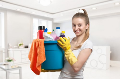 Cleaner wearing PPE while carrying out carpet cleaning work